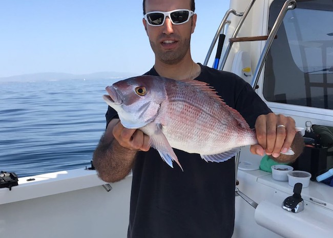 Benny showing his catch on the Fishing Charters tour.