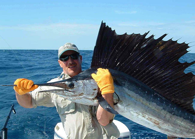Michael showing a stunning fish he caught with his party in the fishing charter.