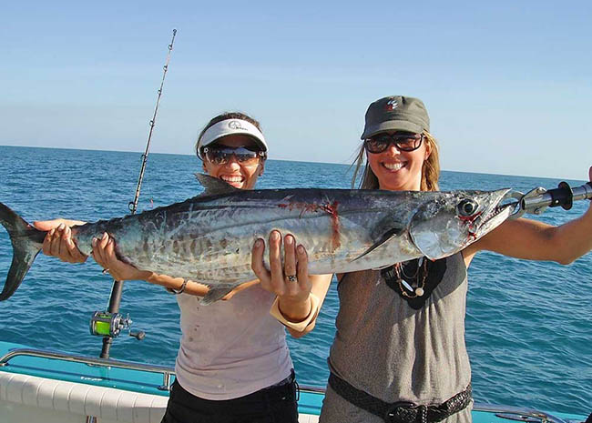 Becky and her sister showing their catch in the fishing charter trip.