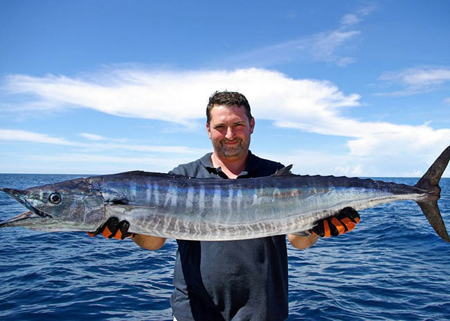 James very satisfied holding the fish he caught on the sea near to Playa del Carmen.