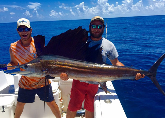 Raul and his brother showing of the big catch they got in Cozumel.