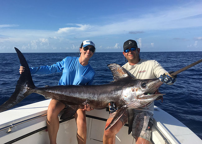 Denise and her brother with their big catch after having an excellent fishing day.